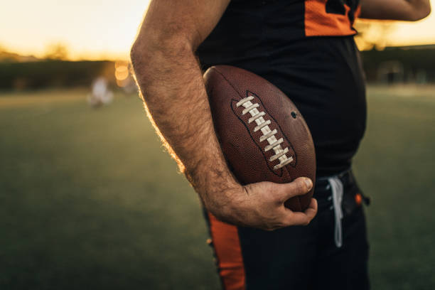 istock American football player holding ball 1126086790