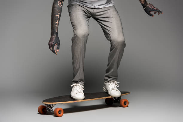 istock low section of stylish tattooed man balancing on skateboard on grey 1126086839
