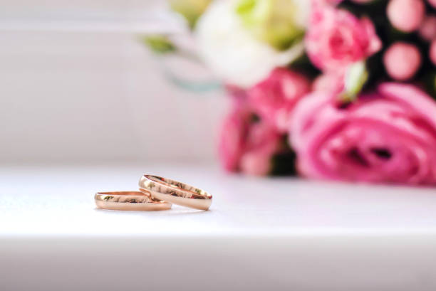 istock Wedding rings next to the bouquet 1126087091