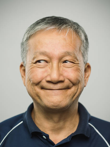 istock Real chinese senior man with playful expression looking to the side 1126087100