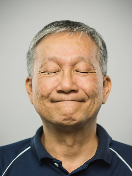 istock Real chinese senior man with playful expression and eyes closed 1126087139