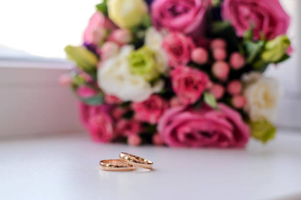istock Wedding rings next to the bouquet 1126088859