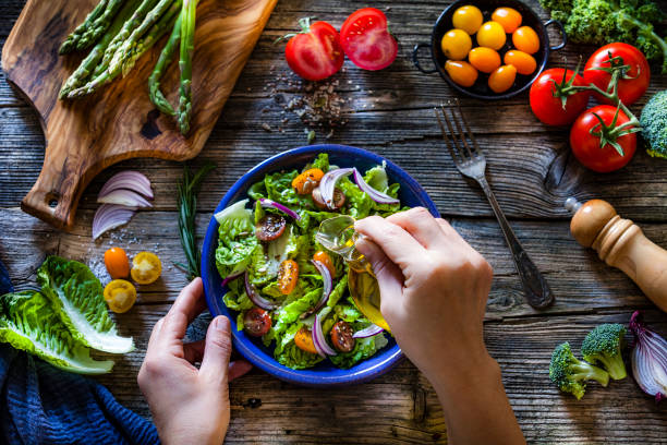 istock Dressing fresh organic vegetables salad with olive oil 1126088950