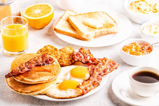 istock Healthy Full American Breakfast with Eggs Bacon Pancakes and Latkes 1126089702