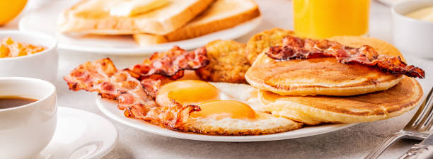 istock Healthy Full American Breakfast with Eggs Bacon Pancakes and Latkes 1126089715