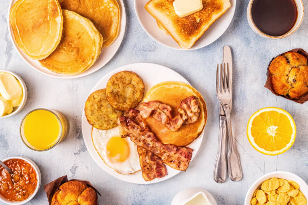 istock Healthy Full American Breakfast with Eggs Bacon Pancakes and Latkes 1126089730
