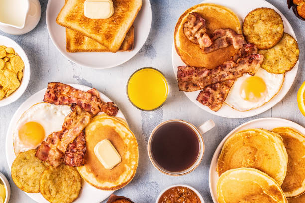 istock Healthy Full American Breakfast with Eggs Bacon Pancakes and Latkes 1126089731