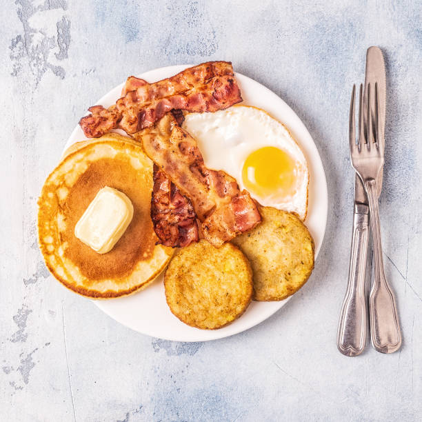 istock Healthy Full American Breakfast with Eggs Bacon Pancakes and Latkes 1126089795