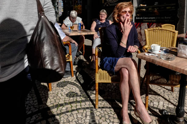Funchal, Madeira, Portugal, January 29, 2019 A smoker at an outdoor cafe.