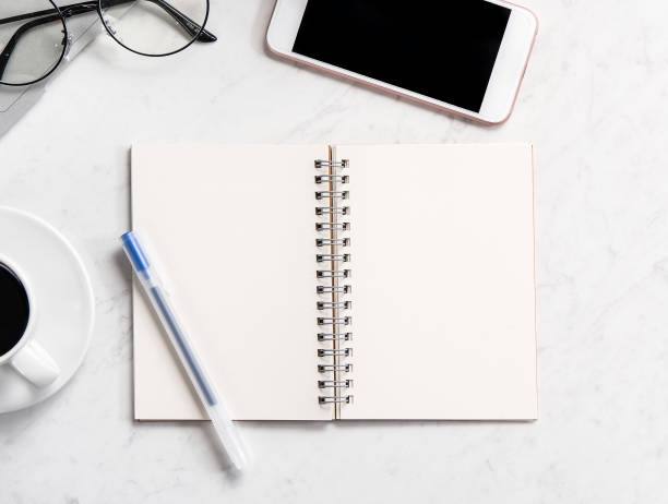 istock Stylized marble office working desk with smartphone, laptop, glasses and coffee, workspace design, mock up, topview, flatlay, copyspace, closeup 1126090258