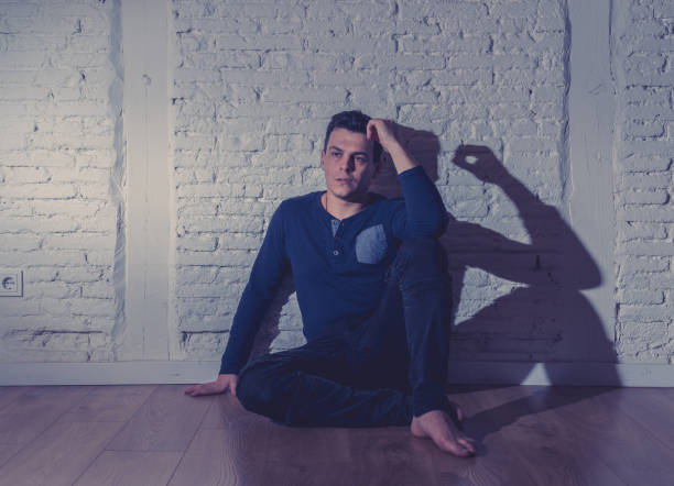 istock Portrait of sad depressed young man crying devastated feeling hurt suffering Depression in People, Sadness, Emotional pain, Loneliness and Heartbroken concept with copy space and dark mood light. 1126095169