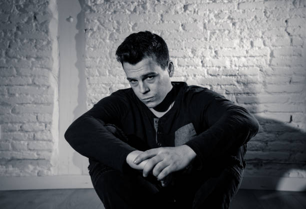 istock Portrait of sad depressed young man crying devastated feeling hurt suffering Depression in People, Sadness, Emotional pain, Loneliness and Heartbroken concept with copy space and dark mood light. 1126095197