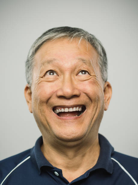 istock Real chinese senior man with excited expression looking up 1126095233