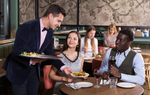 istock Waiter serving couple in restaurant 1126096599