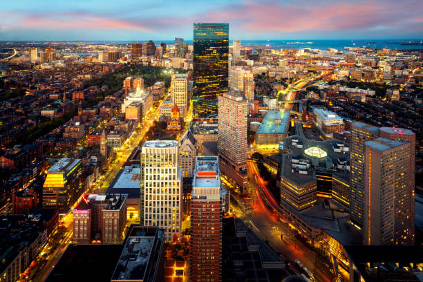 An aerial night view of Boston city center with sunset skyline An aerial night view of Boston city center with sunset skyline, Massachusetts boston prudential building stock pictures, royalty-free photos & images