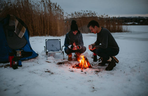 istock Couples camping in winter at the lake 1126101578