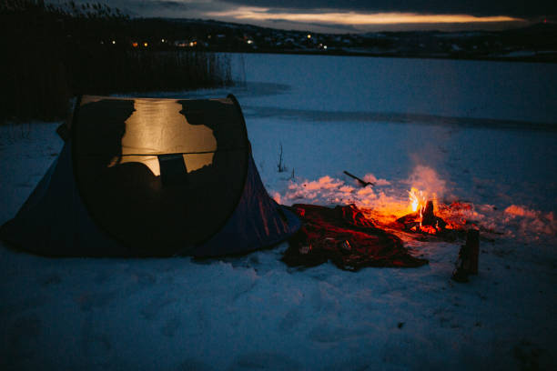 istock Couples camping in winter at the lake 1126101934