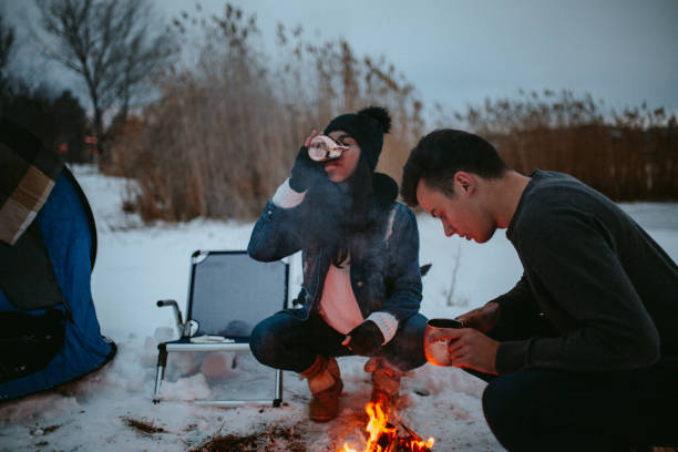 istock Couples camping in winter at the lake 1126102014