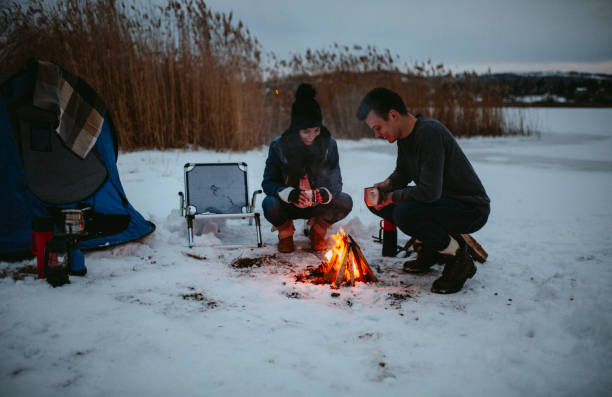 istock Couples camping in winter at the lake 1126102017