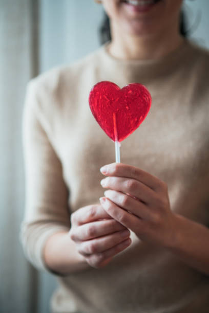 istock Woman holding lollipop 1126102028