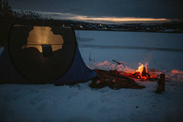 istock Couples camping in winter at the lake 1126102997