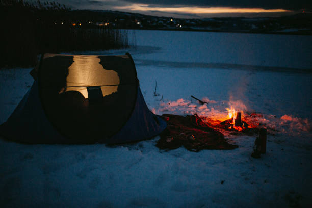 istock Couples camping in winter at the lake 1126103029