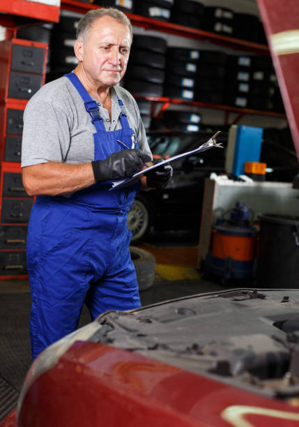 istock Male mechanic taking notes about car repair 1126103060