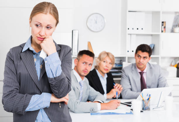 istock Business woman crying in office with working colleagues 1126103243