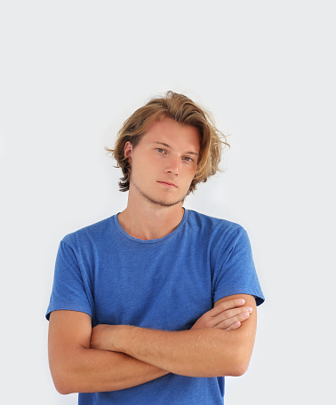 Portrait of attractive young man against isolated white background.