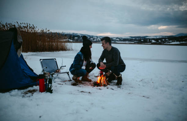 istock Couples camping in winter at the lake 1126105011
