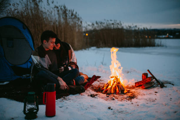 istock Couples camping in winter at the lake 1126105486