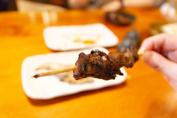 eating rebaa (chicken liver) yakitori, pov - gourmet enjoyment food freshness imagens e fotografias de stock