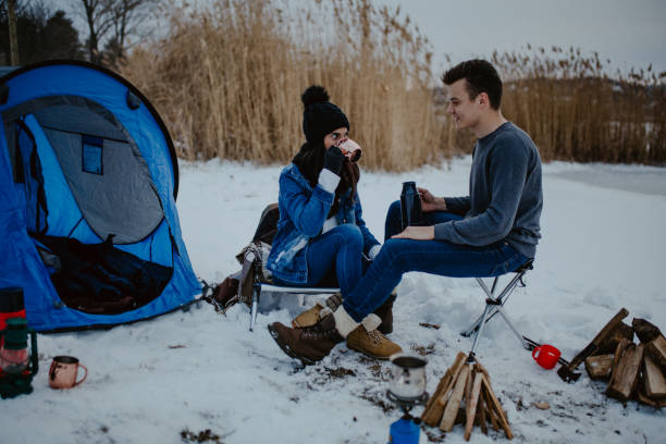 istock Couples camping in winter at the lake 1126106286