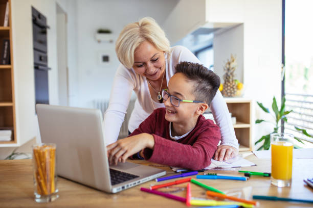 istock Mother and son doing homework on laptop 1126109813