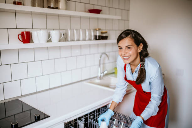 istock Beautiful cleaning lady preparing dishwasher 1126111647