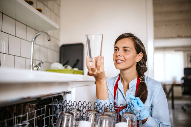 Beautiful cleaning lady preparing dishwasher