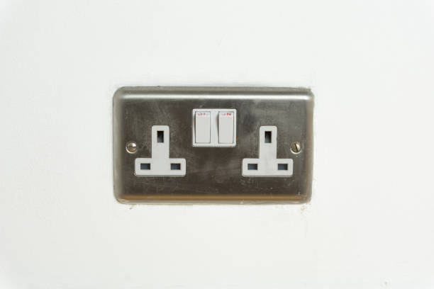 istock Stainless steel UK plug socket on white wall 1126112419