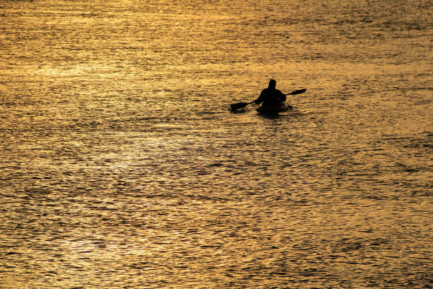 istock Canoeist out in beautiful golden sunrise. 1126112571
