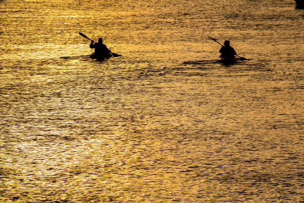 istock Canoeists out in beautiful golden sunrise. 1126112679