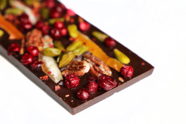istock Dark chocolate with dried cranberries, citrus fruit and nuts, selective focus 1126113106