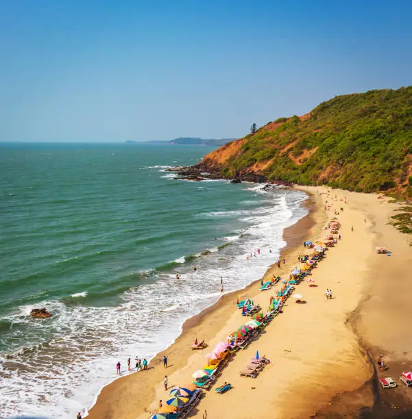 Photo of top view of beach in Goa India vagator beach. people taking sunbath on the beach on shacks