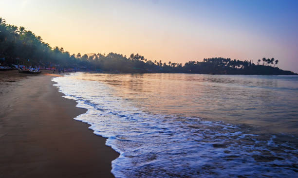 istock Isolated beautiful Palolem beach, Goa in India during sunrise. soft sand with water current waves 1126115356