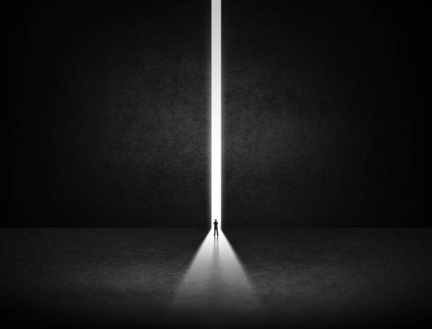 istock businessman stand at the exit way with light in the darkness 1126117773