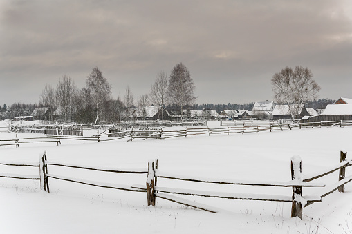 Guszczewina village with houses, farms en fences in the winter in national park Bialowieza in Poland.