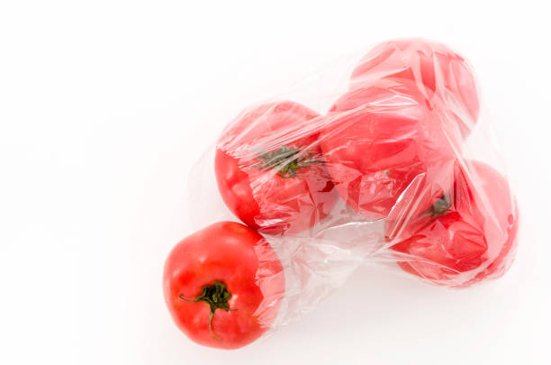 istock Ripe red Tomatoes in Plastic bag on white background 1126121425