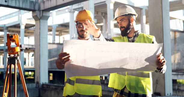 Portrait of construction engineers working on building site Portrait of construction engineers working on building site together foreperson stock pictures, royalty-free photos & images