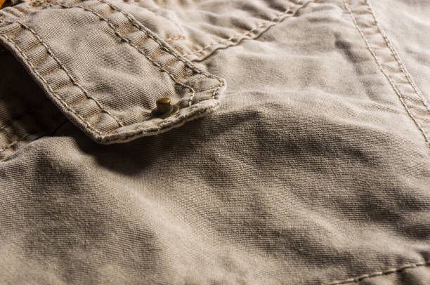 istock clothing items washed cotton fabric texture with seams, clasps, buttons and rivets 1126122949