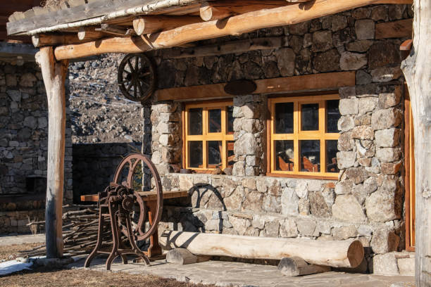 istock Restored Balkar hut made of large stones and wood with wool processing machine 1126123087