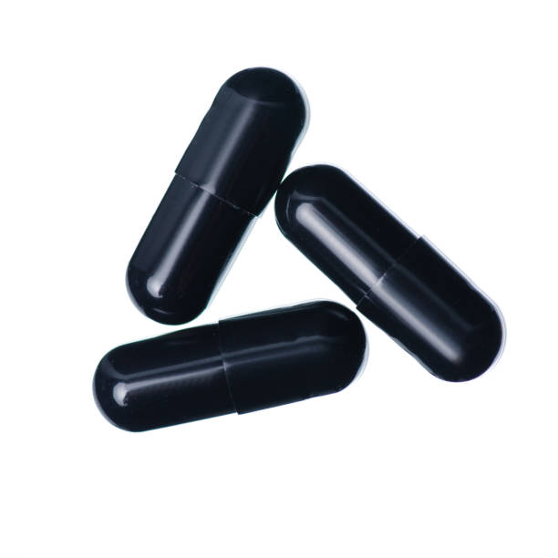 istock Capsule pills medicine pharmacy black on white background 1126123495