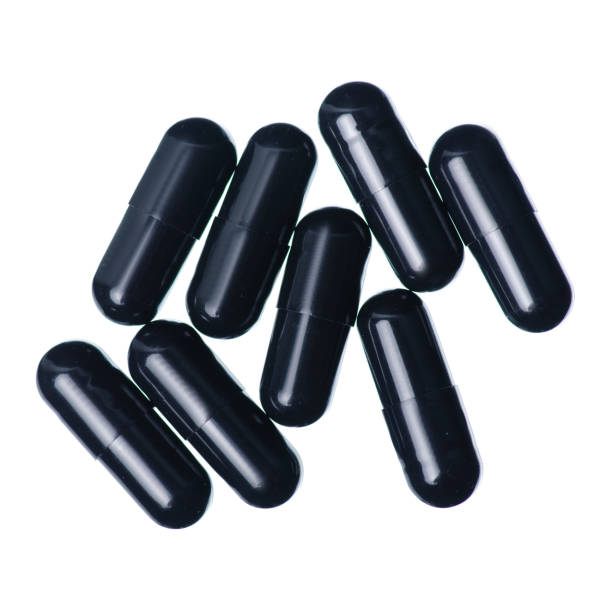 istock Capsule pills medicine pharmacy black on white background 1126123505